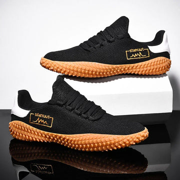 Black mesh streetwear sneakers with textured gum soles, white accents, and a relaxed fit