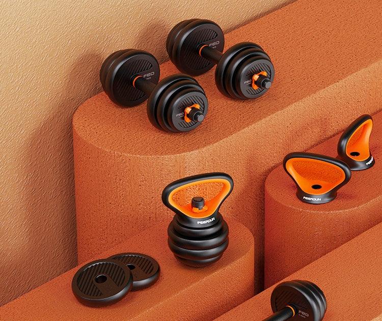 Adjustable black and orange dumbbells and kettlebells with sleek, modern design on textured surface.