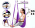 Woman using a purple antigravity yoga swing hammock, soft fabric, relaxed fit, indoor setting