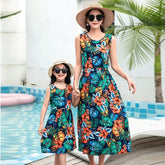 Matching sleeveless floral maxi dresses in vibrant tropical print, lightweight, relaxed fit