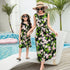Mother and daughter in matching sleeveless black floral dresses, relaxed fit, poolside.