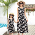 Mother and daughter wearing matching sleeveless black floral print summer dresses with relaxed fit