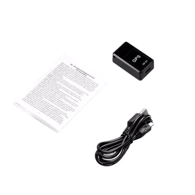 Compact black GPS tracker with USB charging cable and instruction manual on white background