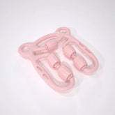 Light pink plastic massage roller with textured wheels on white background