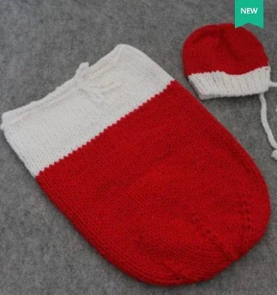 Red and white knit baby sleeping bag with matching hat, soft wool, cozy fit, flat lay