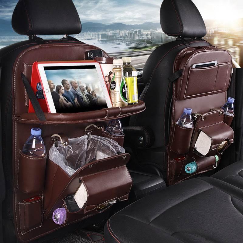 Brown leather car seat organizer with drink holders, tablet stand, tissue box, and storage pockets.