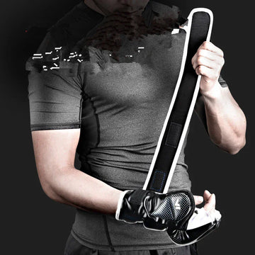Man in fitted grey short sleeve athletic shirt with black training gloves holding padded strap