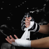 Black and white MMA glove with hand wraps, close fit, synthetic material, sporty style