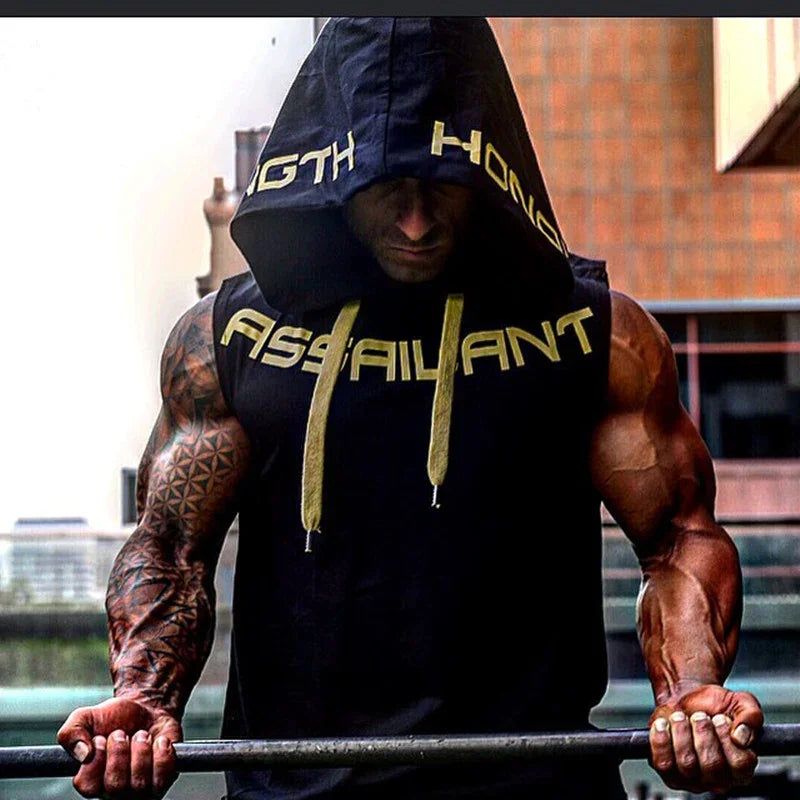 Muscular man in a black sleeveless hooded tank top with bold yellow text and drawstrings, athletic fit