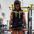 Muscular man in a black sleeveless hoodie with yellow drawstrings, athletic fit, lifting weights in gym