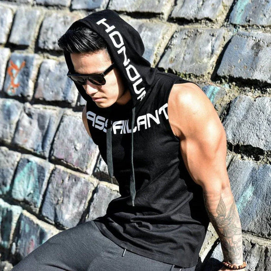 Man wearing sleeveless black hoodie with bold white text, streetwear casual fit