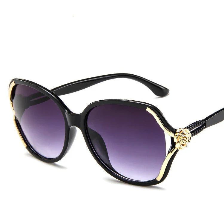 Black oversized sunglasses with gold accents and purple gradient lenses