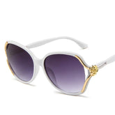 White oversized sunglasses with gold accents and purple gradient lenses