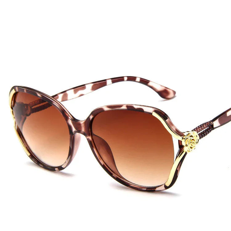 Oversized tortoiseshell sunglasses with gold accents and brown gradient lenses