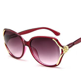 Oversized red sunglasses with gold accents and gradient lenses, feminine streetwear style