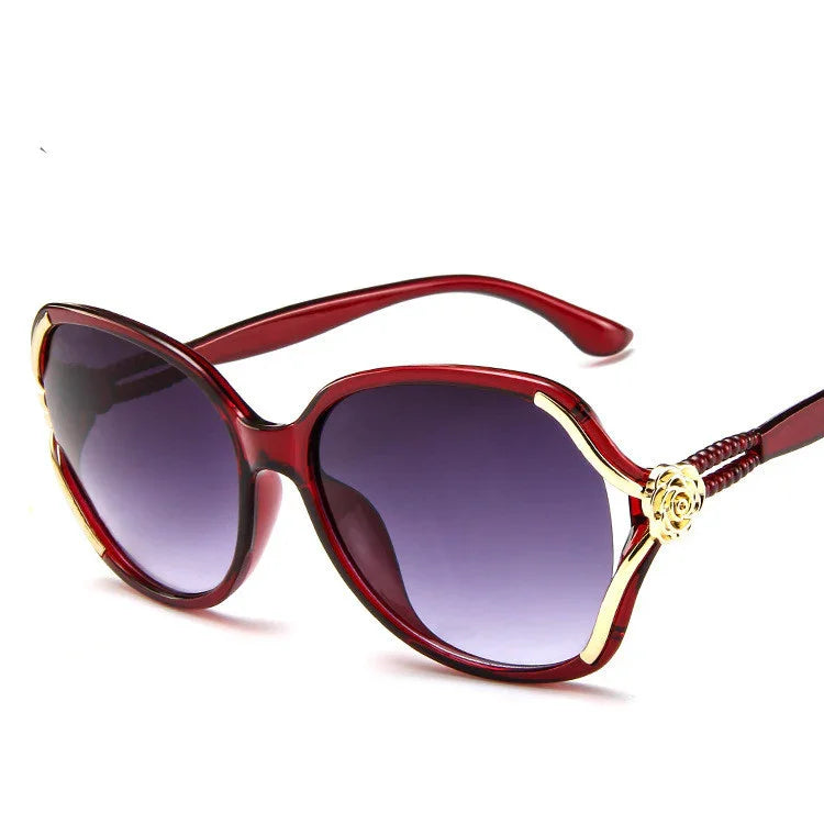 Red oversized sunglasses with gold accents and gradient lenses, plastic frame, curved fit