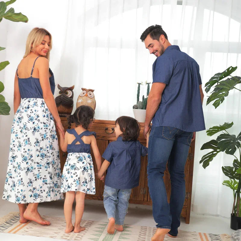Family wearing matching blue and white floral cotton outfits, casual fit, indoor setting.
