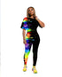 Woman in a fitted black two-piece outfit with colorful paint splash print, streetwear style