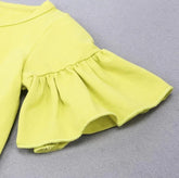 Lime green ruffled sleeve top in soft cotton, relaxed fit, minimalist style on gray background.