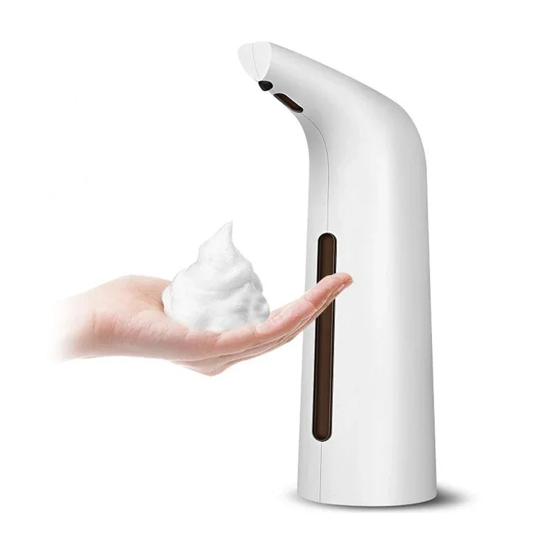 White touchless automatic soap dispenser with foaming soap on a hand