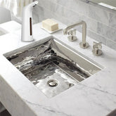 Modern bathroom with a rectangular stainless steel sink, marble countertop, chrome faucet, and touchless soap dispenser.