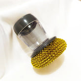 Clear acrylic lid with black trim and gold rhinestone base, modern accessory on white fabric