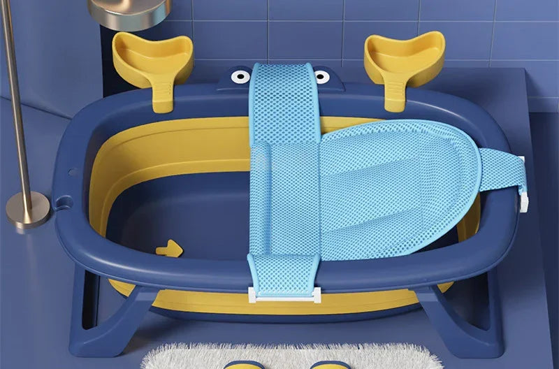 Blue and yellow plastic baby bathtub with adjustable mesh support in modern bathroom.