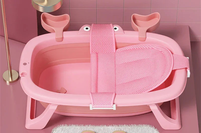 Pink plastic baby bathtub with mesh support and ergonomic design in a modern bathroom