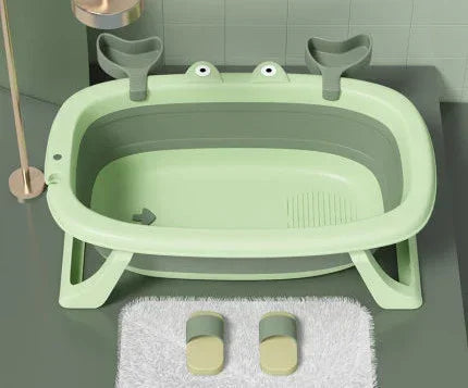 Light green plastic bathtub with cartoon frog accents and wide, sturdy base in a modern bathroom