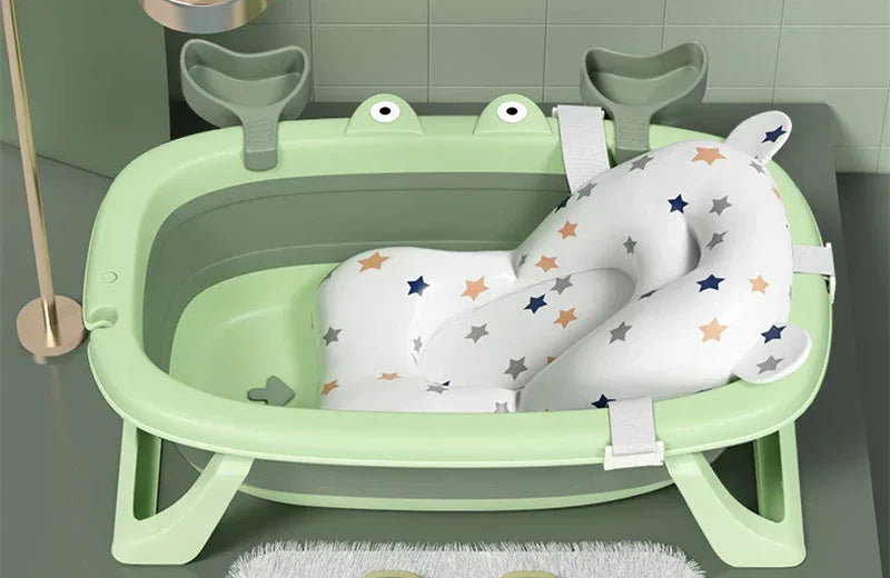 Light green plastic baby bathtub with star pattern plush insert and supportive backrest