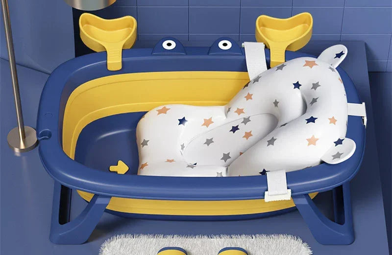 Blue and yellow baby bathtub with star-patterned cushioned insert, sturdy plastic, ergonomic fit