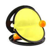 Yellow and black round toy with orange balls, plastic material, modern design, close-up view