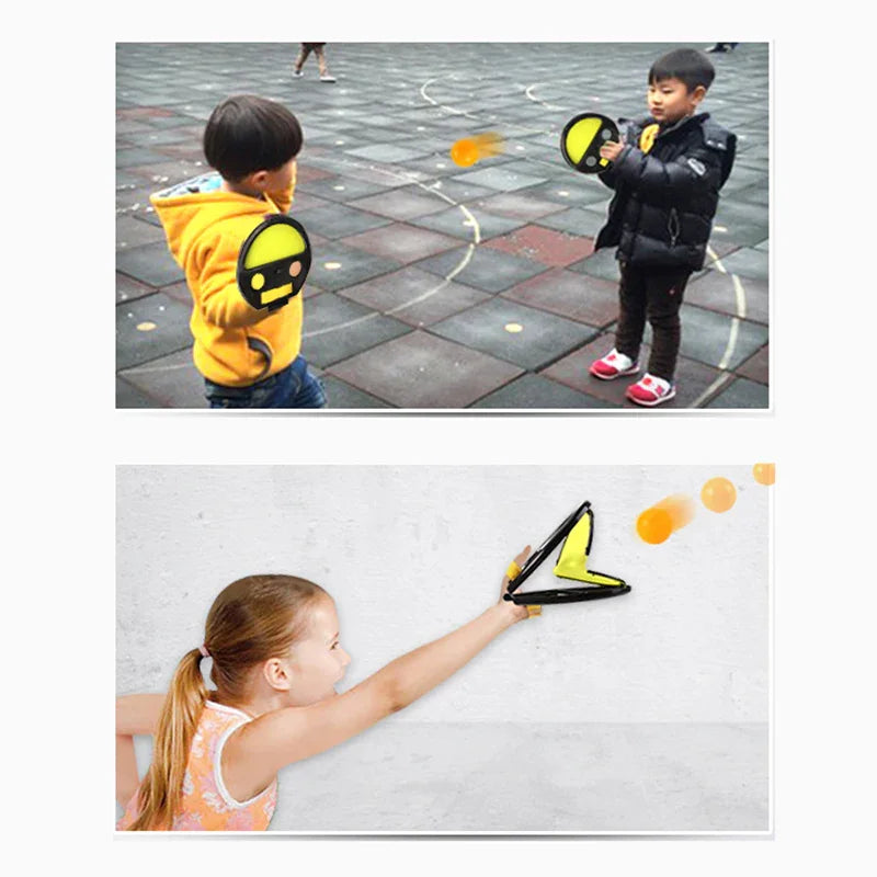 Kids wearing casual jackets and T-shirts playing with soft ball toy paddles outside