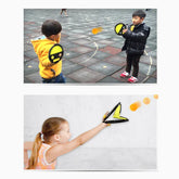 Kids wearing casual jackets and T-shirts playing with soft ball toy paddles outside