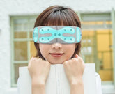 Woman wearing a light blue and grey adjustable eye mask with modern, futuristic design.