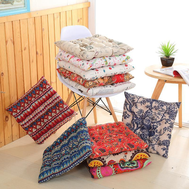 Assorted colorful square floor cushions with bold patterns and soft, tufted cotton fabric