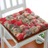 Colorful floral patchwork chair cushion with tufted cotton fabric and soft, plush fit.