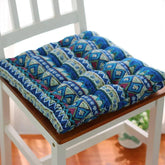 Blue bohemian patterned cotton chair cushion with plush, tufted texture and soft fit.