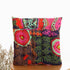 Square throw pillow with vibrant multicolor patchwork, bold patterns, and soft fabric