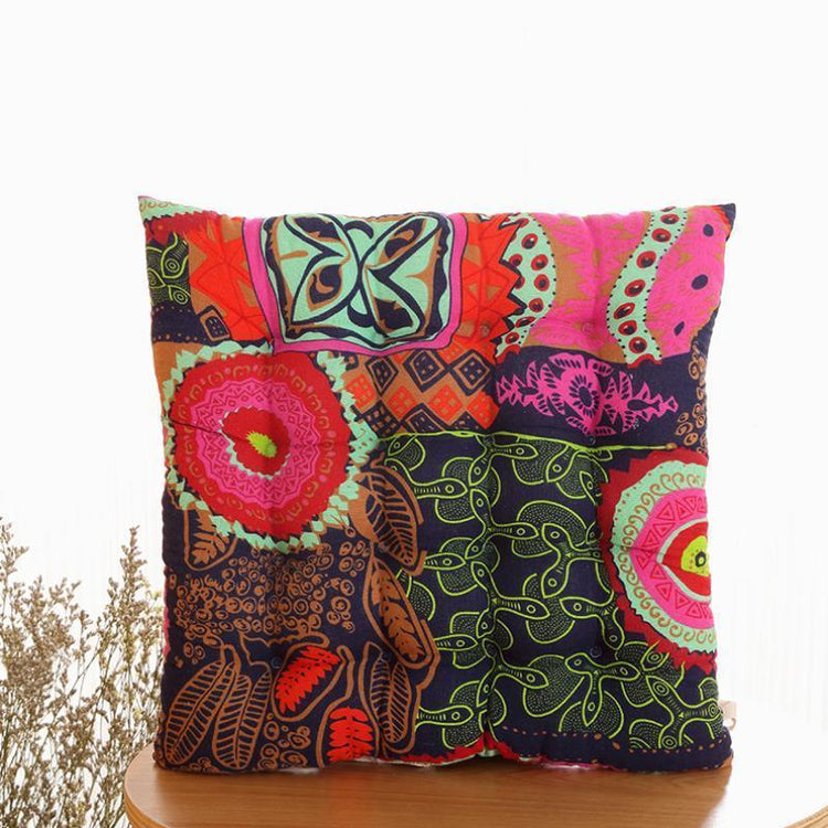 Square throw pillow with vibrant multicolor patchwork, bold patterns, and soft fabric