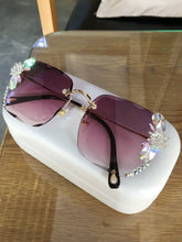 Square oversized sunglasses with purple gradient lenses, crystal embellishments, and gold accents