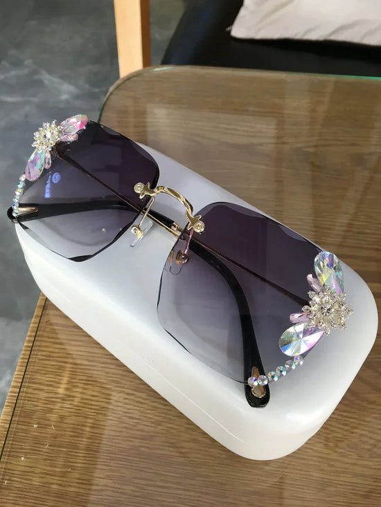 Oversized square sunglasses with purple gradient lenses and crystal floral embellishments
