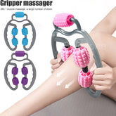 Handheld roller massager with pink textured rollers used on bare leg for muscle relief.