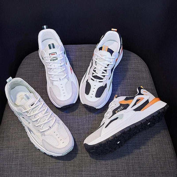 Chunky white and black streetwear sneakers with mesh panels, colorful accents, and athletic fit.