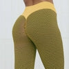 Yellow high-waisted leggings with green geometric mesh pattern, form-fitting athletic wear