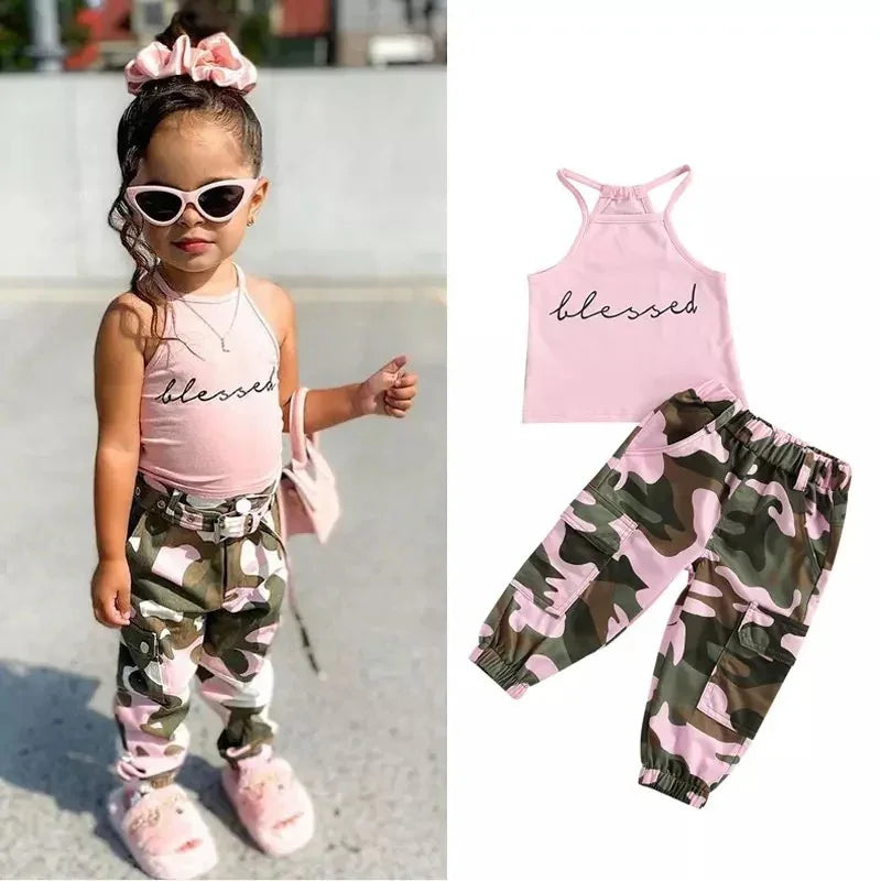 Toddler wearing pink camo pants and pink tank top with &