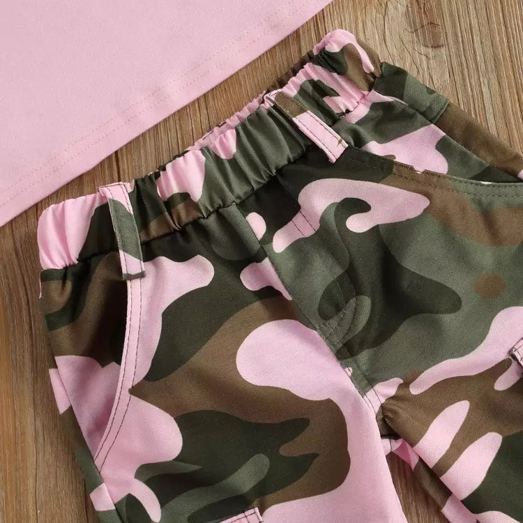 Pink and green camouflage cargo pants with elastic waist, cotton fabric, relaxed fit on wood