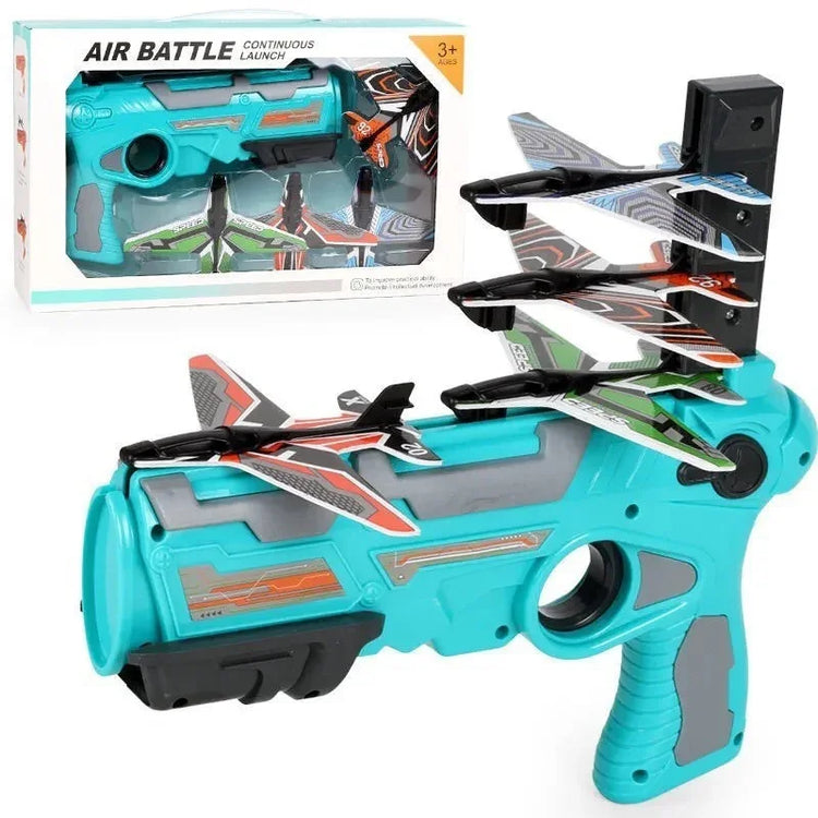 Futuristic turquoise and gray toy launcher with four colorful foam airplanes, ergonomic grip