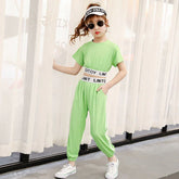 Girl wearing light green short sleeve jumpsuit with sporty elastic waistband and casual fit