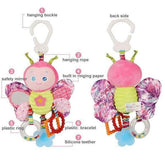 Plush butterfly baby toy with pink and yellow body, patterned wings, teether, and plastic rings